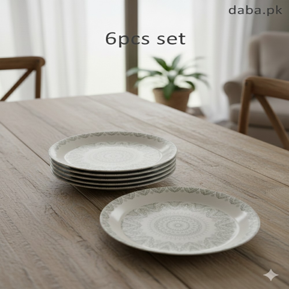 A stack of mandala dinner plates and one single plate arranged on a natural light wood dining table with a soft-focus living room background.